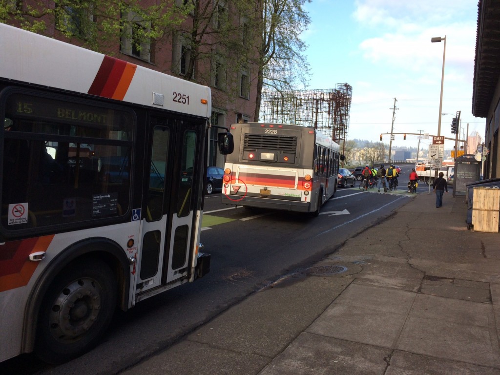 Here, a Trimet bus has its yield sign illuminated but motor vehicle traffic is failing to yield, causing the bus to block the bicycle lane.